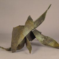 Alt text: Interlocked, torn steel sculpture with abstracted form, view 4