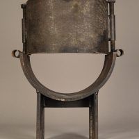 Alt text: Steel sculpture in the shape of a small chair with rounded seat, rear view