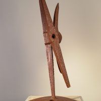 Welded pickaxe sculpture resembling a propeller, angled view