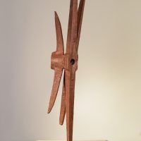 Alt text: Welded pickaxe sculpture resembling a propeller, rear view