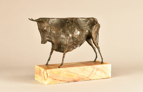 Alt text: Bronze modernist sculpture of a bull atop a marble base