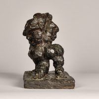 Alt text: Abstract bronze sculpture of two figures embracing