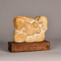 Alt text: Carved marble sculpture of a reclining nude woman
