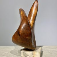 Alt text: Smooth wooden abstract sculpture