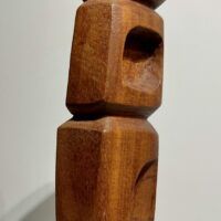 Alt text: Wood carving of a totem