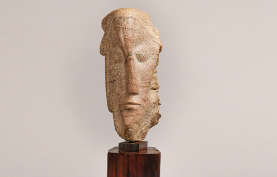 Carved head on reclaimed marble 