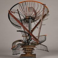 Alt text: Abstract metal sculpture made of a deconstructed oscillating fan