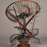 Alt text: Abstract metal sculpture made of a deconstructed oscillating fan