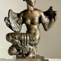 Alt text: Bronze sculpture of Philomela from Greek mythology, kneeling with wings growing from her back