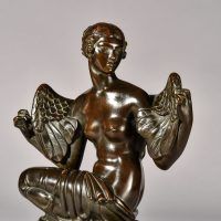 Alt text: Bronze sculpture of Philomela from Greek mythology, kneeling with wings growing from her back