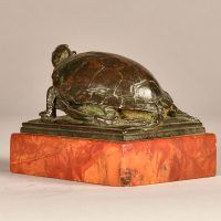 Alt text: Small bronze sculpture of a turtle eating a frog