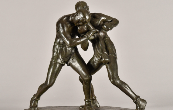 Alt text: Bronze sculpture of two boxers fighting