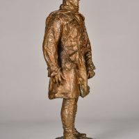 Alt text: Bronze sculpture of a Canadian officer, angled view
