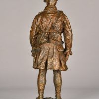 Alt text: Bronze sculpture of a Canadian officer, rear view