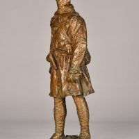 Alt text: Bronze sculpture of a Canadian officer, angled view