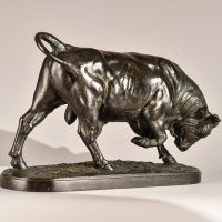 Alt text: Bronze sculpture of a bull with his head down and front right leg lifted, angled view