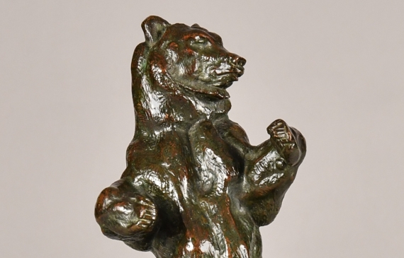 Alt text: Bronze sculpture of a bear standing tall on his hind legs