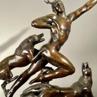 Alt text: Bronze sculpture of Actaeon with dogs