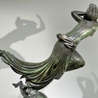 Alt text: Bronze sculpture of a floating woman