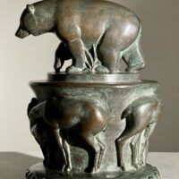 Alt text: Bronze sculpture of a bear on a pedestal