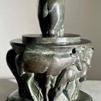 Alt text: Bronze sculpture of a bear on a pedestal