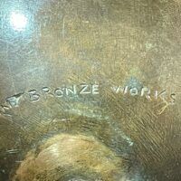 Alt text: Foundry mark on bronze sculpture