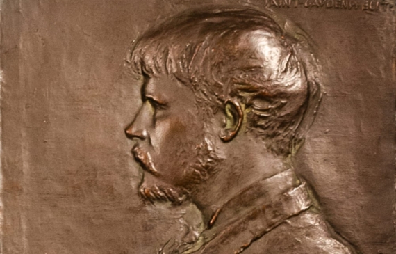 Alt text: Bronze bas relief of Jules Bastian LePage with paintbrush and palette