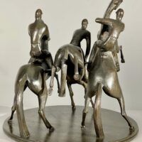 Alt text: bronze sculpture of three men on horseback