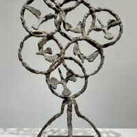 Alt text: Bronze sculpture of birds in circles