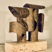 Alt text: Abstract bronze and steel assemblage mounted on a stone block, angled view