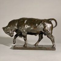 Alt text: Bronze sculpture of a bull preparing to charge, side view