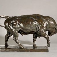 Alt text: Bronze sculpture of a bull preparing to charge, side view