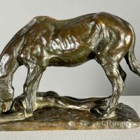 Alt text: Bronze sculpture of a horse and man drinking water