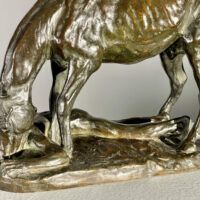 Alt text: Bronze sculpture of a horse and man drinking water
