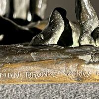 Alt text: Foundry mark detail of a bronze sculpture