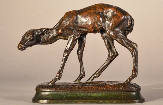 Alt text: Bronze sculpture of a scared fawn, side view