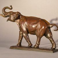 Alt text: Bronze sculpture of a trumpeting elephant, angled view