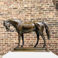 Alt text: Bronze sculpture of an Arabian horse with head slightly lowered, side view