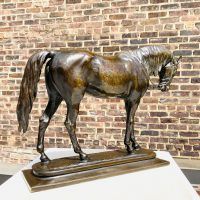 Alt text: Bronze sculpture of an Arabian horse with head slightly lowered, angled view