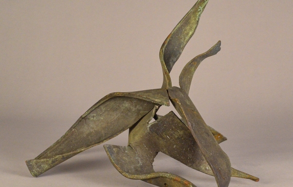 Alt text: Interlocked, torn steel sculpture with abstracted form, view 1