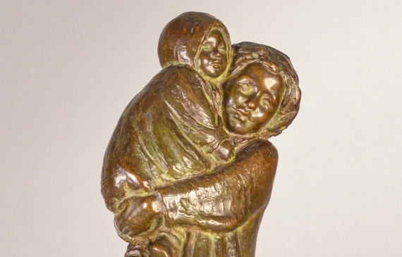 Alt text: Bronze sculpture of a young woman carrying her baby in 1910s clothing, frontal view