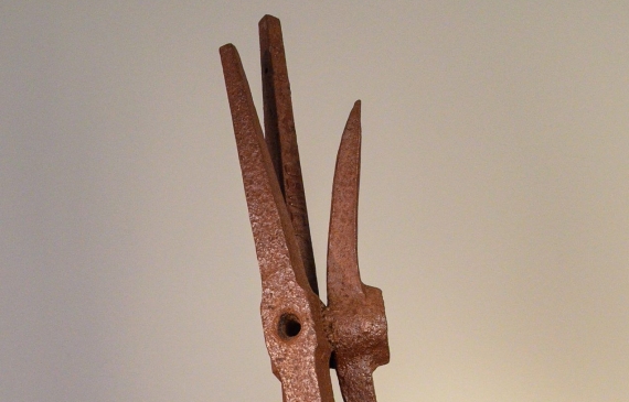 Alt text: Welded pickaxe sculpture resembling a propeller, frontal view