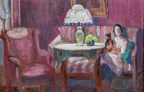 Alt text: Oil painting of a woman sitting in a parlor in an armchair with a dog on her lap, with frame