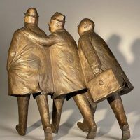 Alt text: Bronze sculpture of three businessmen in trench coats walking together, rear view