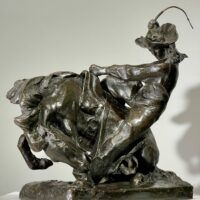 Alt text: Bronze sculpture of a man on a horse with a whip in his hand
