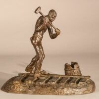 Alt text: Bronze sculpture of a railroad worker