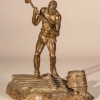 Alt text: Detail of a bronze sculpture of a railroad worker