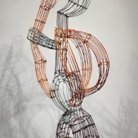 Alt text: Abstract wire sculpture of a hitchhiker