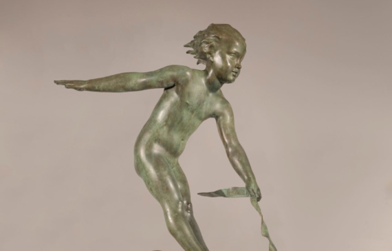 Alt text: Bronze sculpture of a boy riding a dolphin