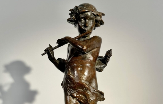 Alt text: Bronze fountain sculpture of Pan playing flute